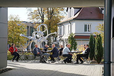 Visitantes tomando café sob o sol