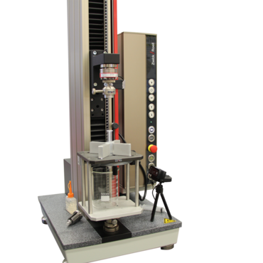 Test fixture to determine the breakaway force and glide force of syringes