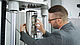 User grips specimen in the servohydraulic testing machine HA100