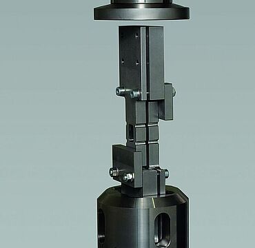 Filled hole compression test with ASTM support device between compression platens. Filled hole compression test to ASTM D6742 with ASTM support device between compression platens.