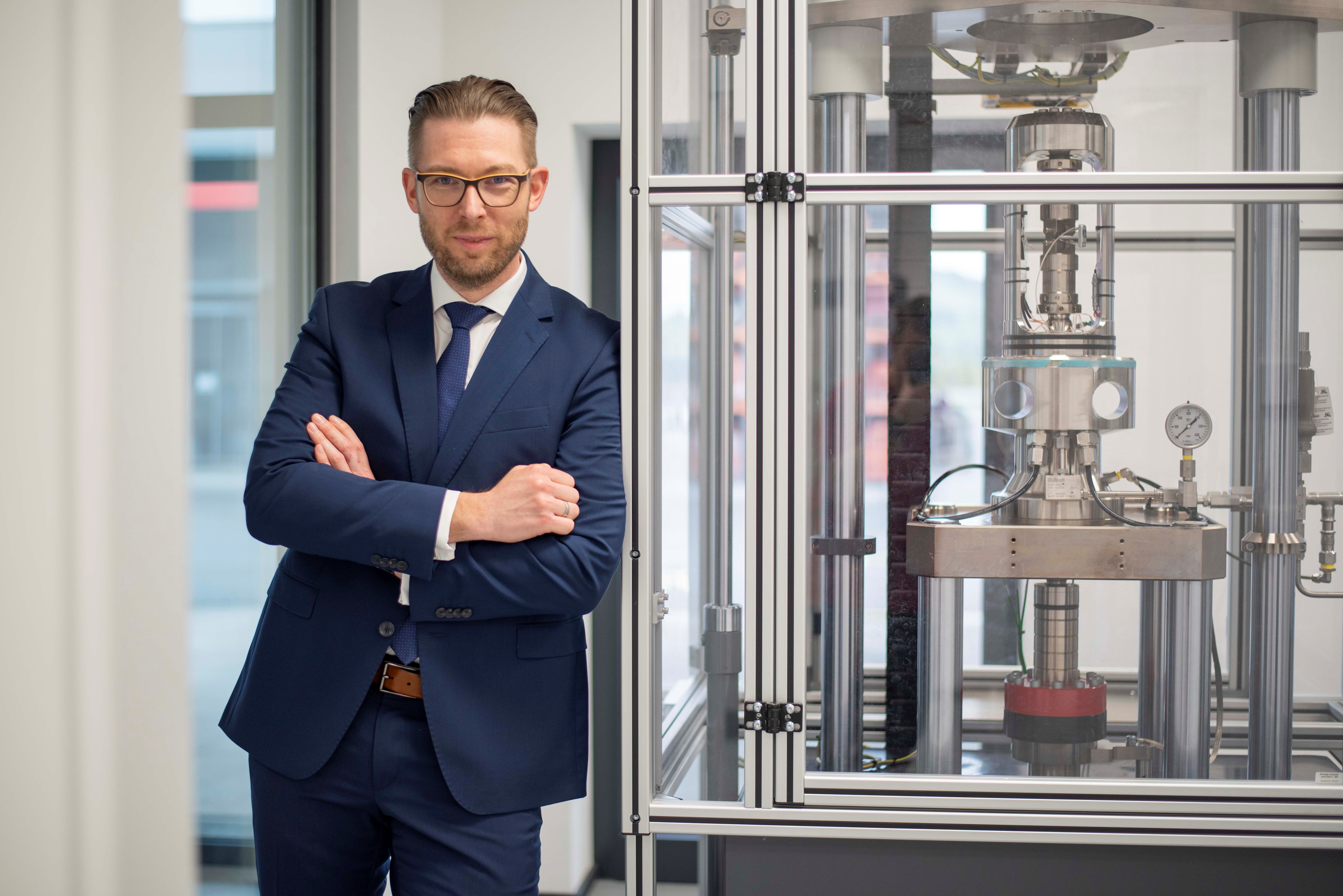 Bernd Schrittesser vor einer ZwickRoell Prüfmaschine für Wasserstoffprüfungen in einem Prüflabor