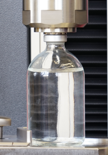 Test fixture for determining the residual seal force (RSF) on vials referenced in USP 1207