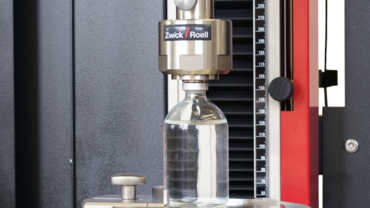 Test fixture for determining the residual seal force (RSF) on medical vials referenced in USP 1207