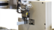 The robot holds the specimen in the cross-section measuring device