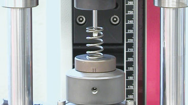 Precision compression spring test device