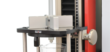 Test fixture for performing autoinjector spring simulation